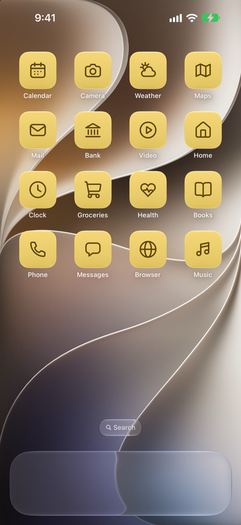 An iPhone Home Screen with sixteen Wattle Gold glass icons: calendar, camera, weather, map, mail, bank, video, home, clock, groceries, health, books, phone, messages, browser and music